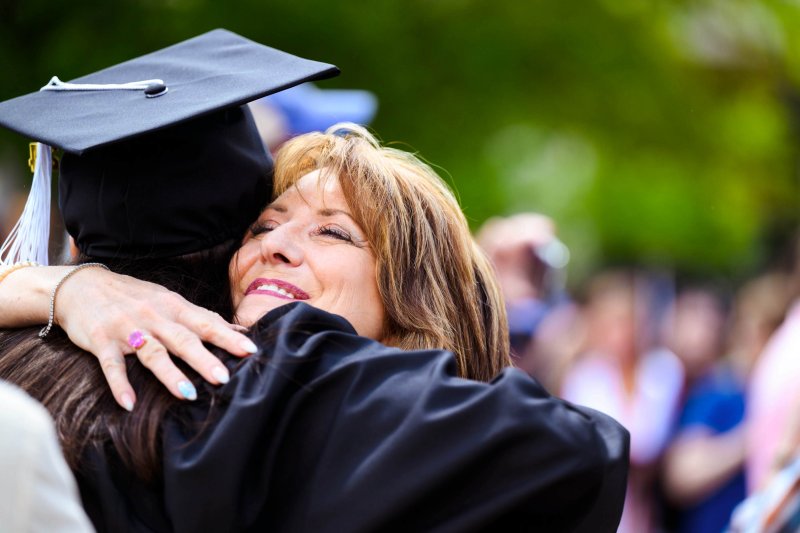parent hugging her graduate