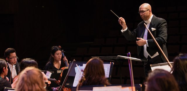 Faculty member conducting an Orchestra