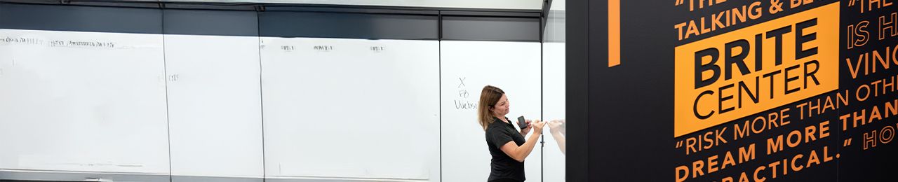 professor writing on whiteboard