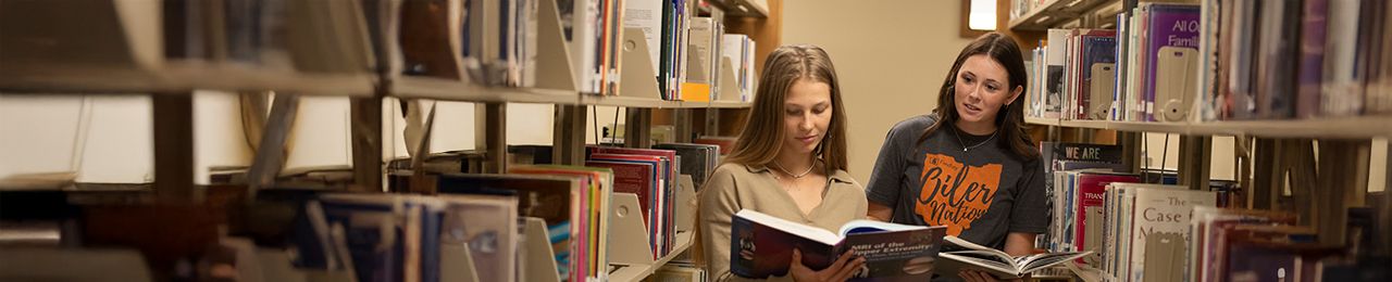 two students reading books