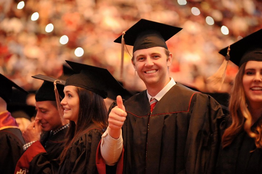 smiling graduate giving a thumbs up
