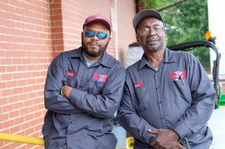 two employees smiling