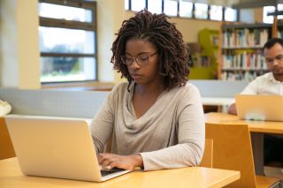 Woman looking at laptop