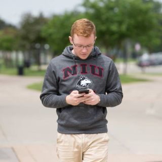 Student using mobile device on campus