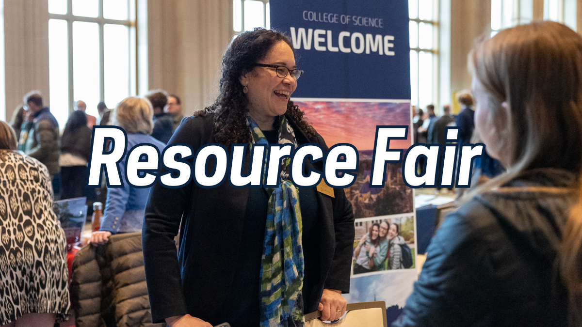 A professor from the College of Science speaks to students at resource fair.