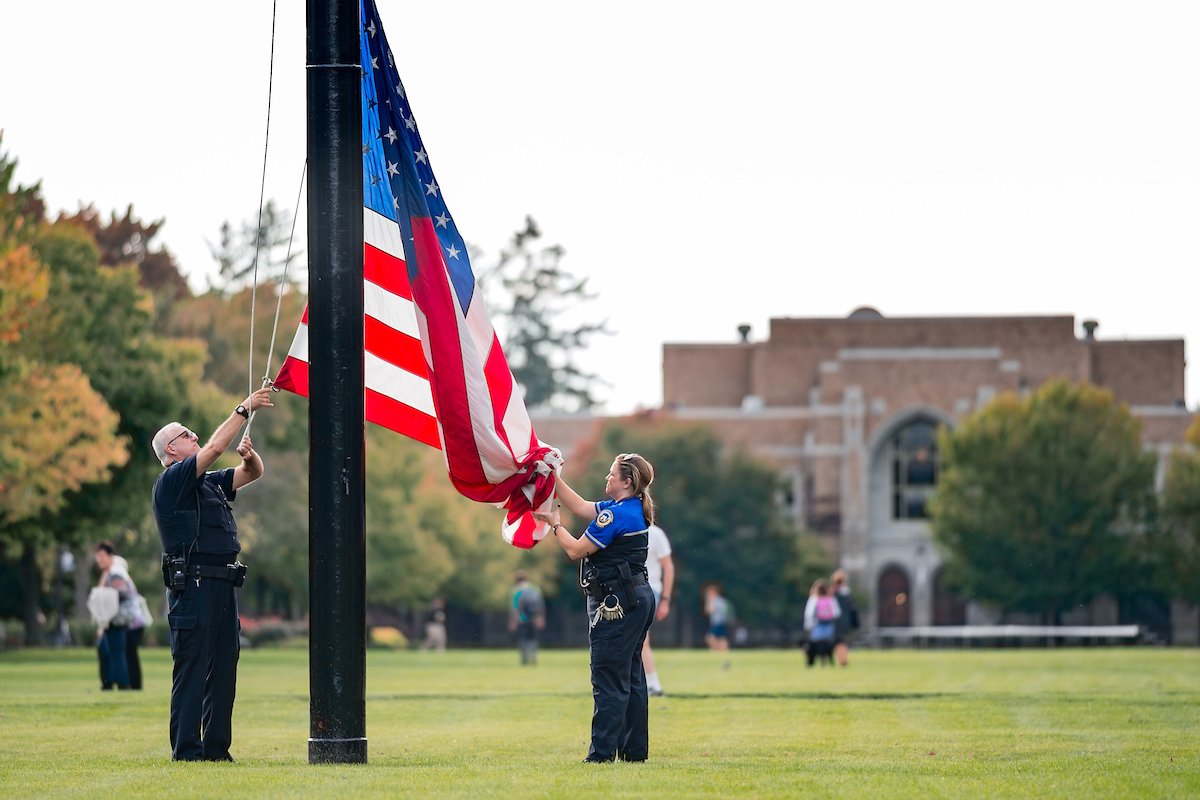 Notre Dame Security Police officers lower the U.S. flag on South Quad