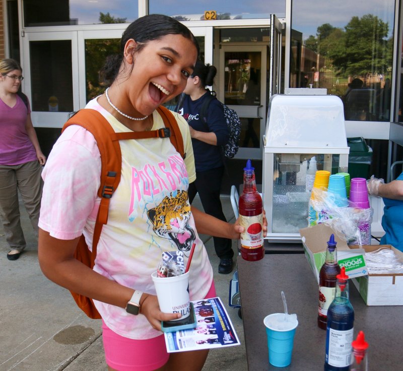 Student making a snow cone on campus.