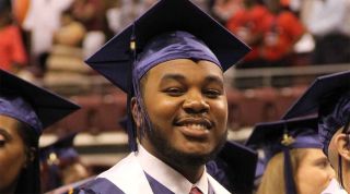 UA-PTC graduate smiling at commencement.