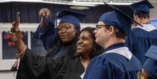Three UA-PTC graduates taking a selfie picture.