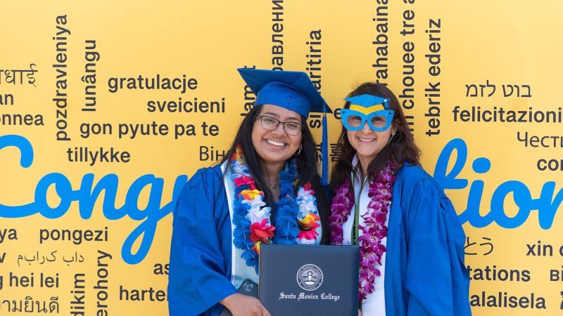 Graduates at step and repeat wall