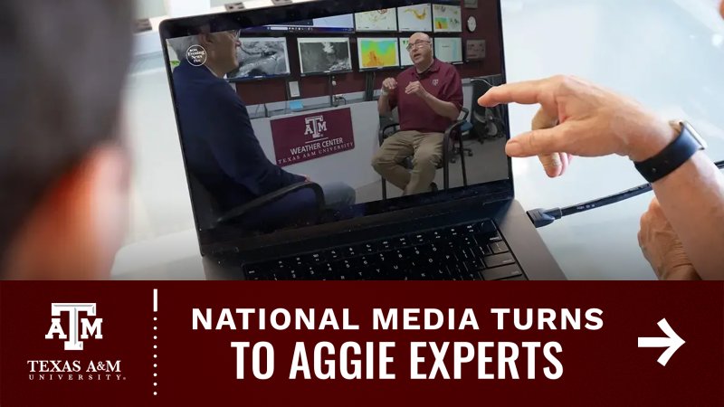 A person points at a laptop screen displaying an interview inside the Texas A&M Weather Center, with various weather maps and equipment visible in the background.  A maroon banner at the bottom displays the Texas A&M logo and the text "National Media Turns To Aggie Experts" next to a white arrow pointing right.