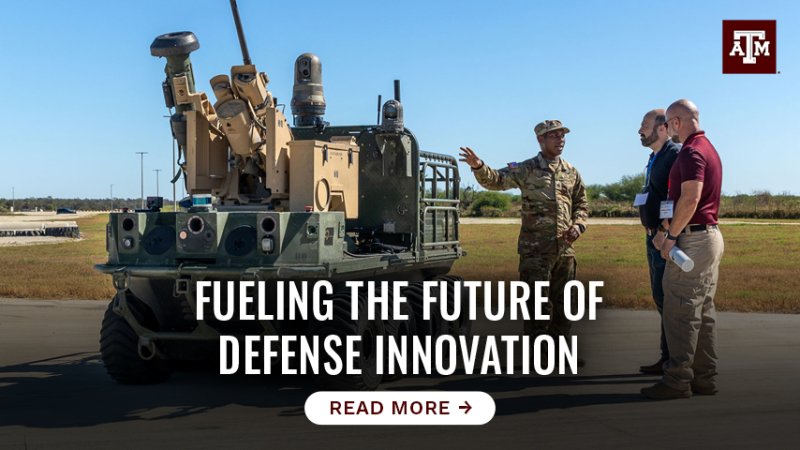 Two men and a soldier discussing a military vehicle. Text reads "Fueling the future of defense innovation, tap here to read more."