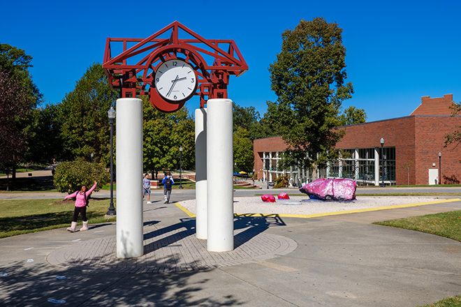 The tradition is that if you walk under the clock tower you won't graduate on time. Most walk around.