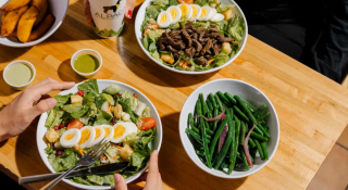 image of a salad with egg on top and side plate of green beans