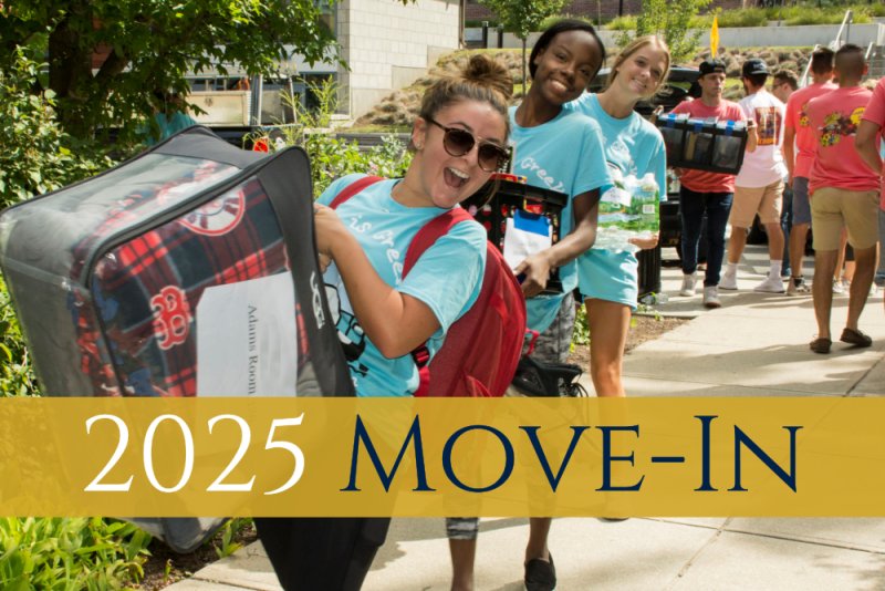 Students smiling and carrying belongings during the 2024 Move-In event at the University of Rhode Island, with a yellow banner displaying '2024 Move-In' across the image