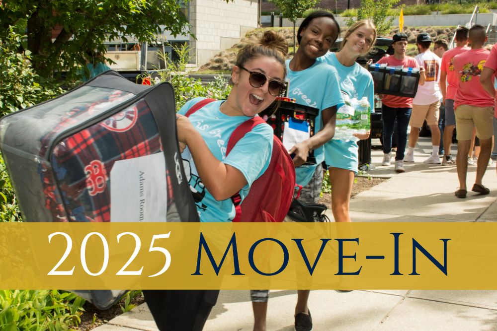 Move-in banner with smiling students carrying luggage
