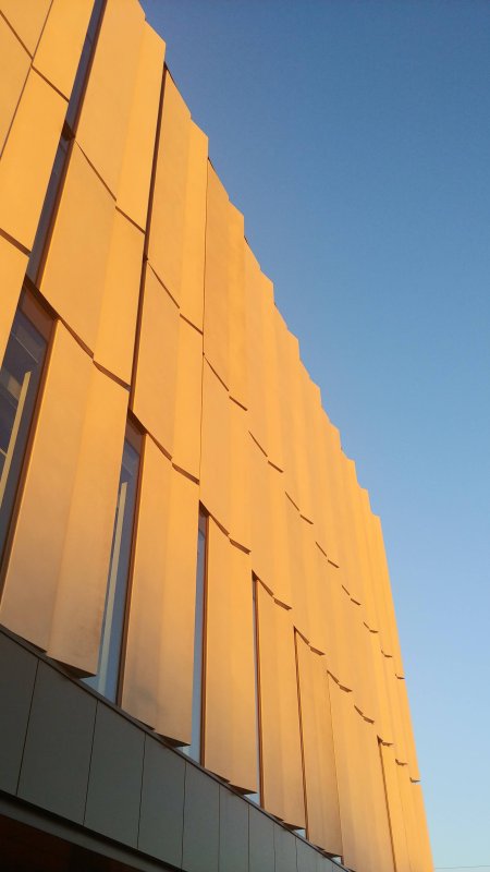 The golden light of a winter sunrise hitting Shawenjigewinning hall.