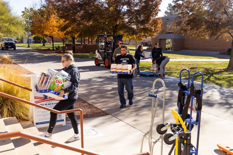 Volunteers brining food drive food to building