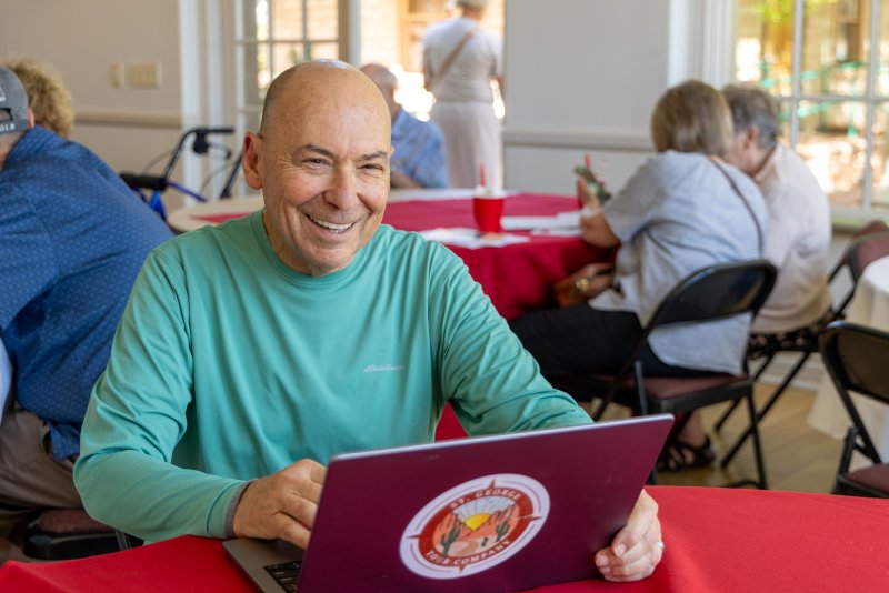 ICL member on computer at ice cream social