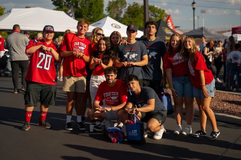 Photo of students posing with the bison hand symbol