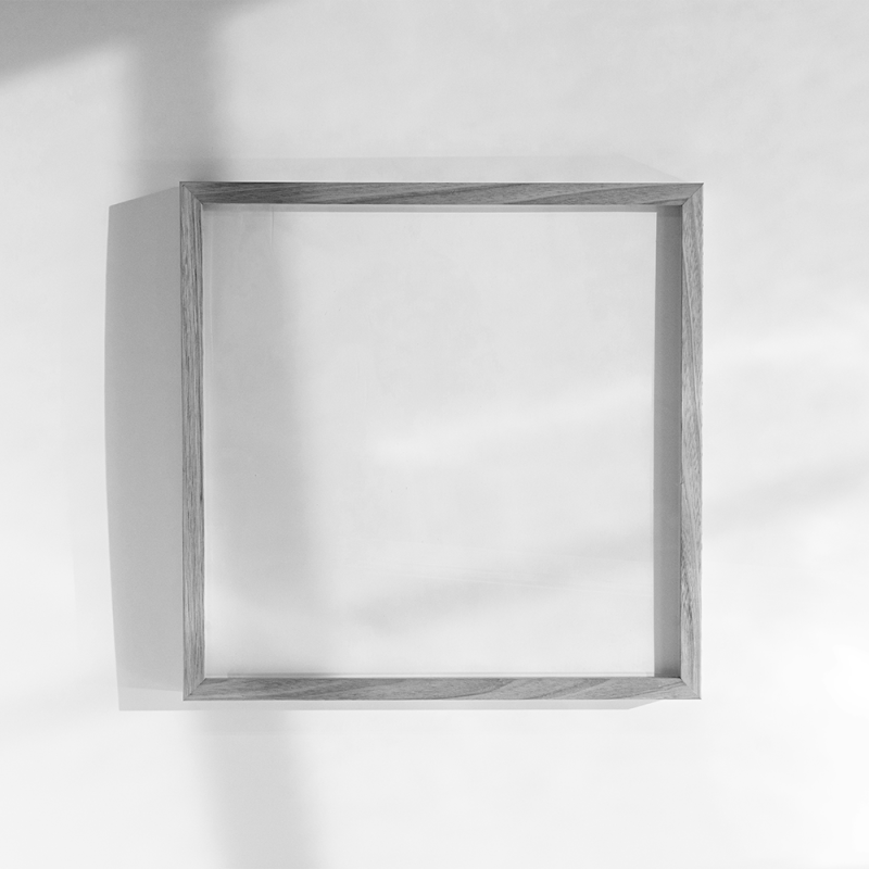 Empty picture frame mounted to a white wall