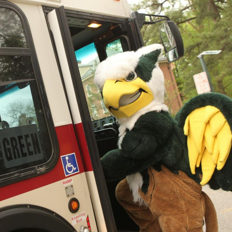 Griffin mascot getting on a bus