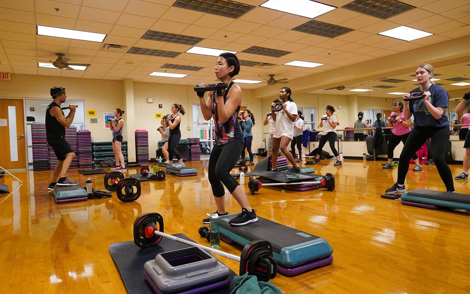 People using weights during an exercise class.