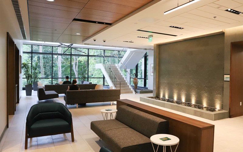 Interior view of the McLeod Tyler Wellness Center with seating areas and a large window wall.