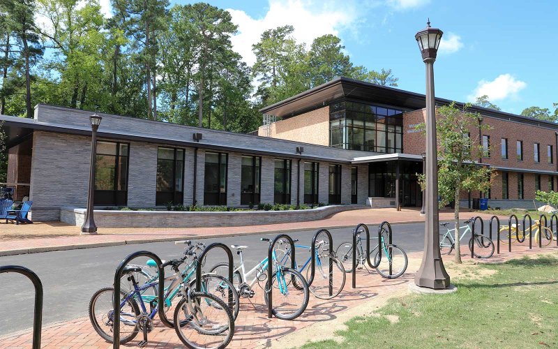 Exterior view of the McLeod Tyler Wellness Center with bike racks in front.