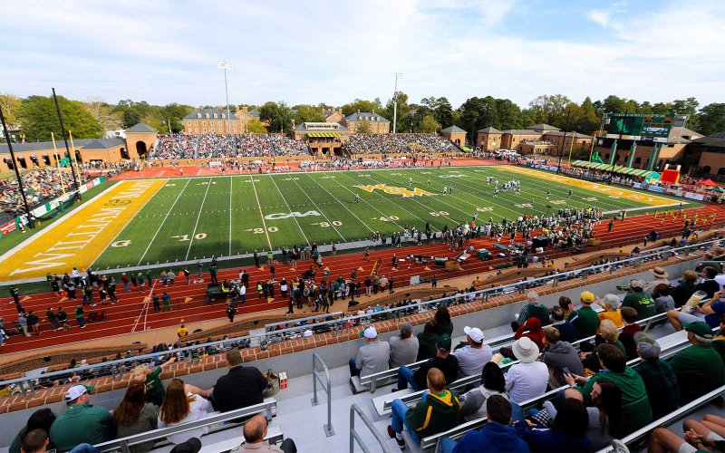 Football game at Zable Stadium with players on the field and spectators in the stands.